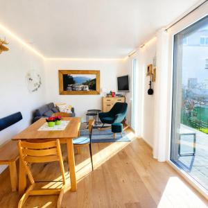 a living room and dining room with a table and chairs at Ferienhaus Haus im Garten in Feldkirch