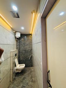 a bathroom with a toilet and a shower at Hotel RK in Ujjain