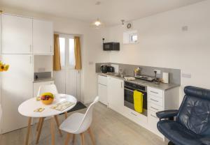 a small kitchen with a table and a table and chairs at The Bake House in Worthing