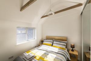 a bedroom with a bed and a window at The Bake House in Worthing