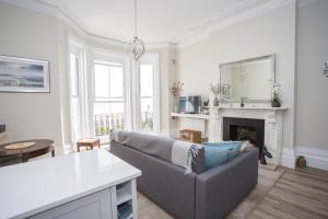 a living room with a couch and a fireplace at Seaways Apartment in Worthing