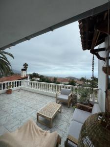 a patio with a table and chairs on a balcony at Holiday Feel - La Orotava in La Orotava +5 photos
