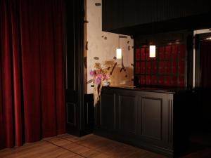 a room with a counter with a vase of flowers at Wittmore Hotel GL- Adults Only, Small Luxury Hotels in Barcelona