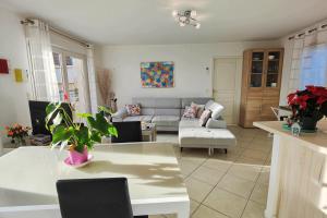 a living room with a couch and a table at Spacious appartment with terrace and shared pool in Fréjus