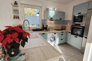 a kitchen with a sink and a washing machine at Spacious appartment with terrace and shared pool in Fréjus +11 photos