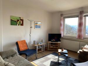 a living room with a couch and a tv at Ferienwohnung Graupner in Schwarzenberg