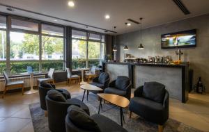 a waiting room with chairs and a bar at Nobel Inn Hotel in Belgrade