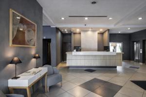 a lobby with a reception desk and a waiting room at Nobel Inn Hotel in Belgrade