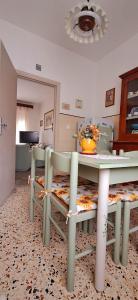 a dining room with a table and some chairs at Orlando House 1975 in Montecchio +13 photos