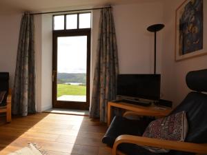 a living room with a large window and a television at 2 Bed in Blagdon oc-tforg in Butcombe