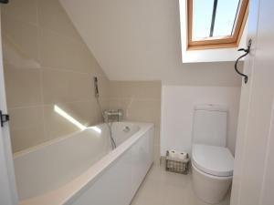a white bathroom with a tub and a toilet at 2 Bed in Blagdon oc-tforg in Butcombe +6 photos