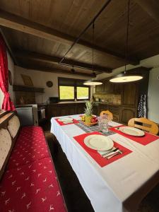 a dining room table with a red and white table cloth at Apartment Alpen Lodge 52 in Aschau