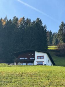 a white building in the middle of a field at Apartment Alpen Lodge 52 in Aschau