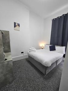 a bedroom with a large white bed in a room at Edinburgh City Hotel in Edinburgh