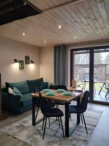 a living room with a table and a couch at Domki i tyle in Rabka-Zdrój
