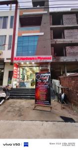 a sign in front of a building at Hotel RK in Ujjain