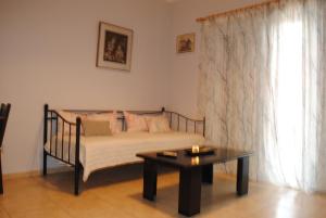 a bedroom with a bed and a coffee table at Sweet Suites in Amalias