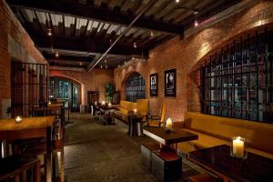 a restaurant with tables and chairs and a brick wall at The Liberty, a Luxury Collection Hotel, Boston in Boston