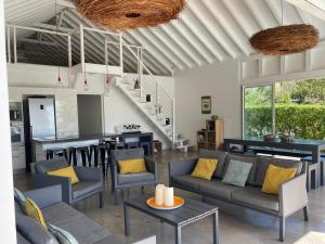 a living room with couches and a kitchen at Villa Ever Blue in Le Vauclin