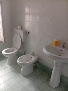 a bathroom with a toilet and a sink at Sunset hostel Palermo in Palermo