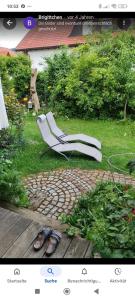 a picture of a white chair in a yard at Ferienwohnung Röder am Schwimmteich in Bischofsheim an der Rhön +4 photos