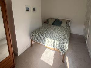 a small bedroom with a bed in the corner at Crown Cottage in Belper