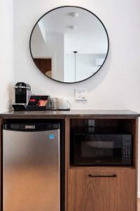 a kitchen with a microwave and a mirror on the wall at Room with a King-Size Bed Downtown Quebec in Quebec City