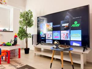 a living room with a large flat screen tv at Central Apartments' Privat-Sauna free Parking AmurResidence FamilyConcept in Iaşi