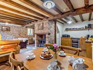 a kitchen and dining room with a table and a fireplace at 2 Bed in Nottingham oc-47032 in Besthorpe