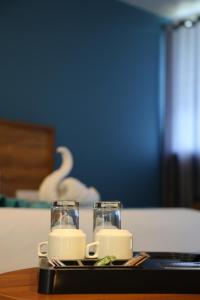 a tray with two glasses of milk on a table at Mount Minar Munnar in Anachal