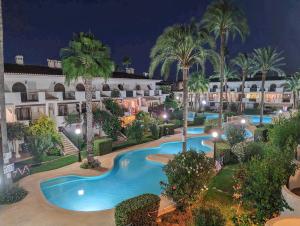 an aerial view of a resort pool at night at Beachfront in Denia Alicante in Denia