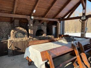 an outdoor kitchen with a large stone oven at Alexia Agropension in Pui