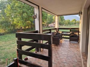 a screened in porch with a view of the yard at Alexia Agropension in Pui