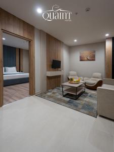 a living room with a couch and a table at Quaint Hotel Erbil in Erbil