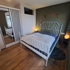 a bedroom with a white bed in a room at Goldener Blick in Stollberg