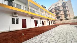an empty courtyard of a building with red dirt at La Nature Retreat in Puducherry Airpoert