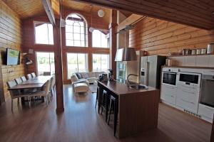 a kitchen and living room with a table and a dining room at Päijänteen Helmi 1 in Jämsä +14 photos