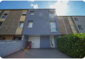 a apartment building with a garage and a driveway at Chez moi in Mont-Saint-Martin