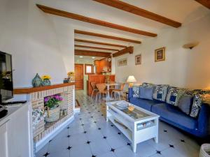 a living room with a blue couch and a table at Beachfront in Denia Alicante in Denia