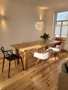 a dining room with a wooden table and chairs at Haus Sonnen mit 3 Apartments in Nettetal