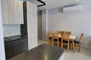 a kitchen and dining room with a table and chairs at Olive Qerret in Golem +17 photos