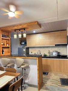 a kitchen with wooden cabinets and a table and chairs at Maria Staycation House in Davao City