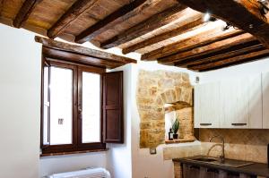 a kitchen with wooden ceilings and a window at Casa Vacanze Todi in Todi +9 photos