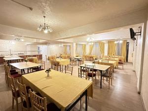 a dining room with tables and chairs in a room at Turkiye Hotel - Free Massage - Free Swimming Pool in Baku