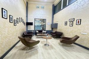 a living room with chairs and a couch and a table at Turkiye Hotel - Free Massage - Free Swimming Pool in Baku