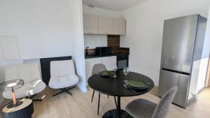 a kitchen with a table and chairs in a room at Savigny Vineyard View & SPA in Savigny-lès-Beaune