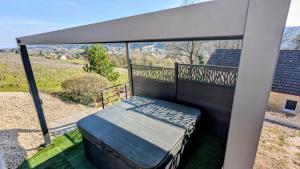 a porch with a bed on a balcony at Savigny Vineyard View & SPA in Savigny-lès-Beaune +6 photos
