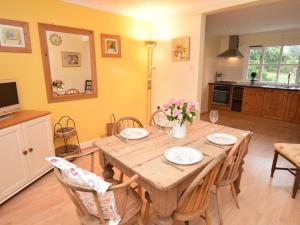 a dining room with a wooden table and chairs at 2 Bed in Sherborne oc-53673 in Chetnole +10 photos