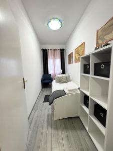a bedroom with a bed and a book shelf at Apartment Ambretta in Savudrija +20 photos