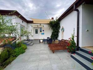 a patio with a bench in front of a house at Apartment Ambretta in Savudrija